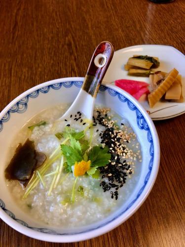 a bowl of soup with a spoon on a table at Umeoka Ryokan in Nagano