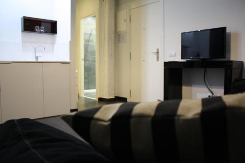 a living room with a couch and a flat screen tv at Los Balcones del Arte in Santander
