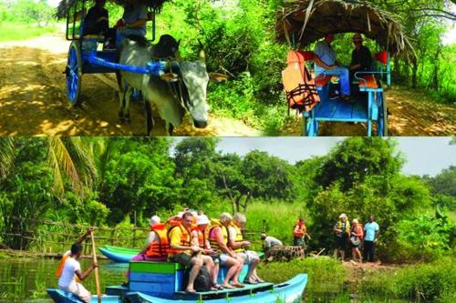 a group of people riding in boats on a river at Relax Nature Villa in Sigiriya