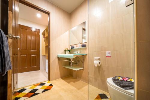 a bathroom with a toilet and a glass shower at Dreambeach 2-villas in Panwa Beach
