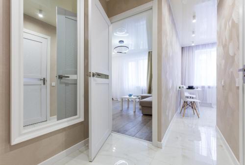 a hallway with a door leading to a living room at Apartments on Kopernyka in Kyiv