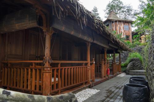 a bamboo house with a thatched roof at Tira Vilagna Suites & Spa in Kintamani