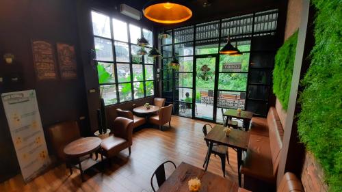 an overhead view of a restaurant with tables and chairs at The Peak Guest House in Jember