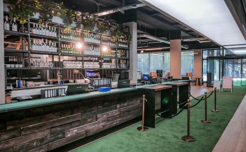 a bar in a building with a green carpet at LOFTSTYLE Hotel Hannover, Best Western Signature Collection in Hannover