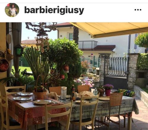 a table and chairs in a garden with a table and chairsktop at B & B Da Giusy in Corte Franca