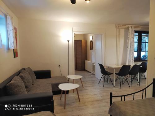 a living room with a couch and a table and chairs at Ubytovanie Filloména in Liptovský Ján