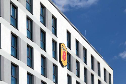 a building with a sign on the side of it at Super 8 by Wyndham Oberhausen am Centro in Oberhausen
