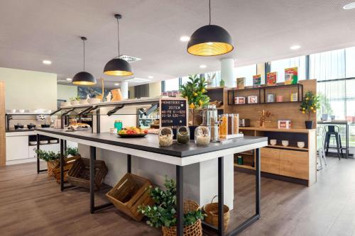 a kitchen with a large island in the middle at Super 8 by Wyndham Oberhausen am Centro in Oberhausen
