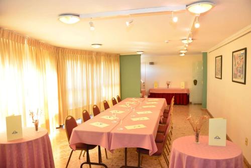 a room with a long table with chairs and tablesearcher at Alfa Suites - Montevideo in Montevideo