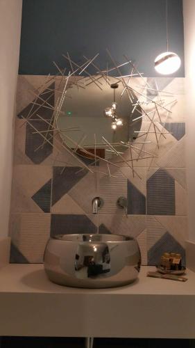 a bathroom with a sink and a mirror at Murallas de Jayrán Hotel Boutique in Almería
