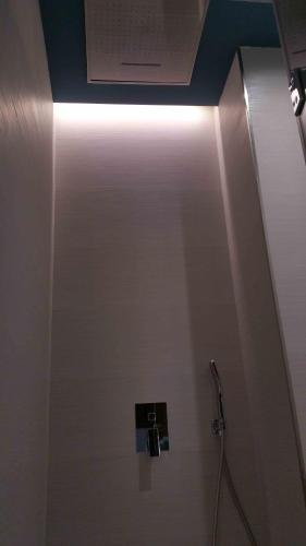 a bathroom stall with a door with a light at Murallas de Jayrán Hotel Boutique in Almería