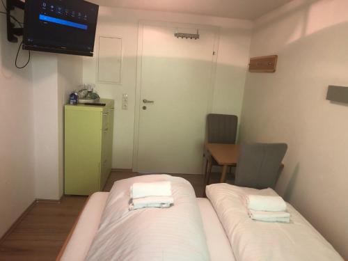 a small room with two beds and a television at Schmitten Haus in Zell am See