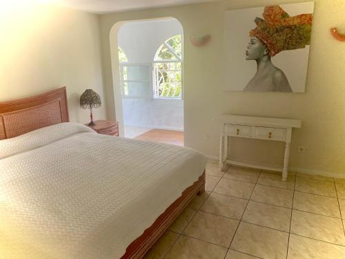 a bedroom with a white bed and a window at Sunny House, Chayofa in Chayofa