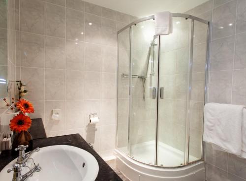 a bathroom with a shower and a sink at The Walnut Tree Inn in Northampton