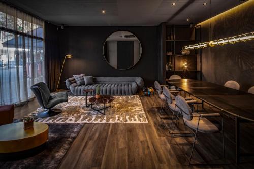 a living room with a couch and a table at Baxter Hotel in Visp