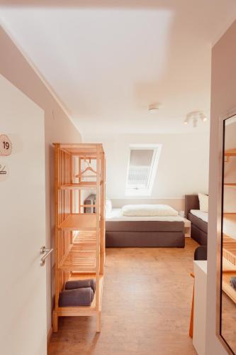 a bedroom with a bed and a ladder in a room at Landhotel Belitz Garni in Küsten