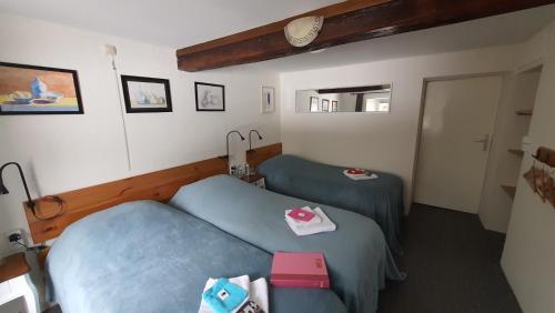 a hotel room with two beds and a mirror at La Fermette Blanche in Nadrin