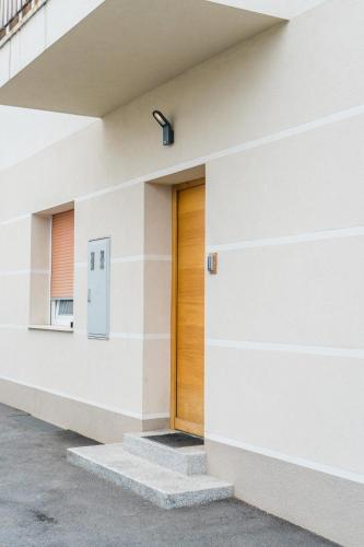 a door on the side of a building at Kamr’ca in Ljubljana