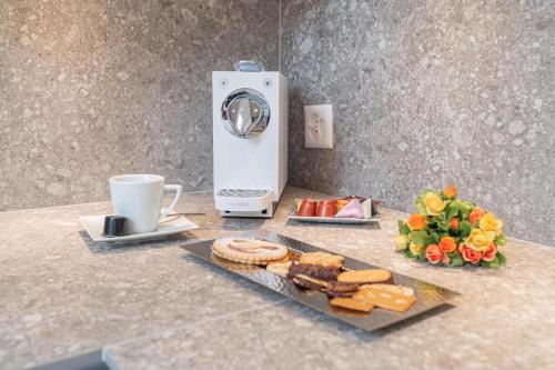 a counter with a plate of bread and a cup of coffee at Jolimont Apartments in Zermatt