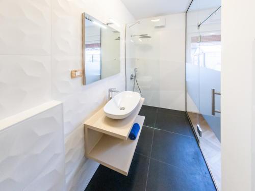 a bathroom with a sink and a mirror at Kamr’ca in Ljubljana