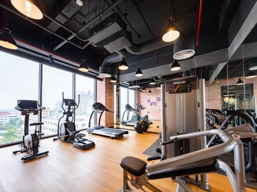 a gym with treadmills and elliptical machines at SOJO Hotel Nam Dinh in Nam Ðịnh
