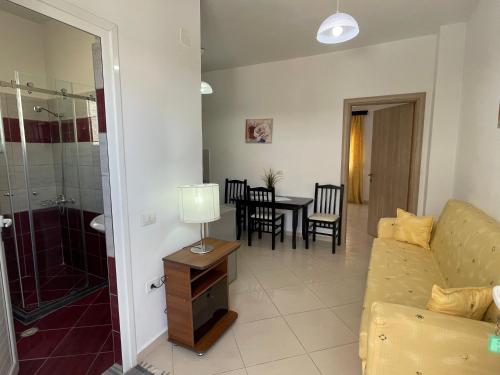 a living room with a couch and a table at Relax Apts Saranda in Sarandë