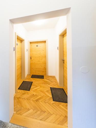 a room with wood floors and two mats on the floor at Kamr’ca in Ljubljana