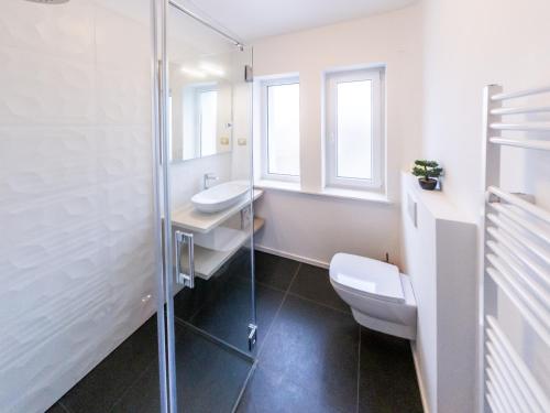 a bathroom with a toilet sink and a shower at Kamr’ca in Ljubljana