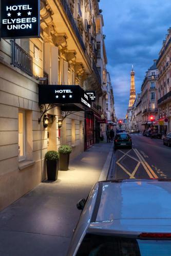 a car parked on a city street with the eiffel tower at Elysées Union in Paris