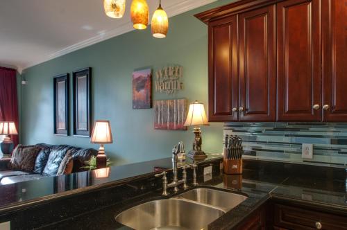 a kitchen with a sink and a couch at Vacation Home 5 Mins to Down Town 2 Bedrooms 2 Baths Garden Area Hot Tub in Nashville