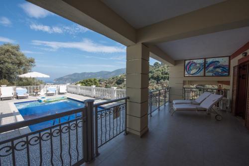 a balcony with a view of a swimming pool at Gallis Villa in Pefkias