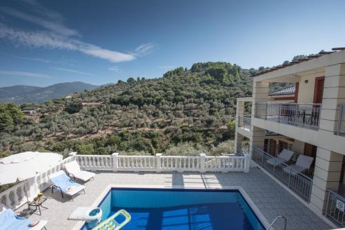 a villa with a swimming pool and a balcony at Gallis Villa in Pefkias