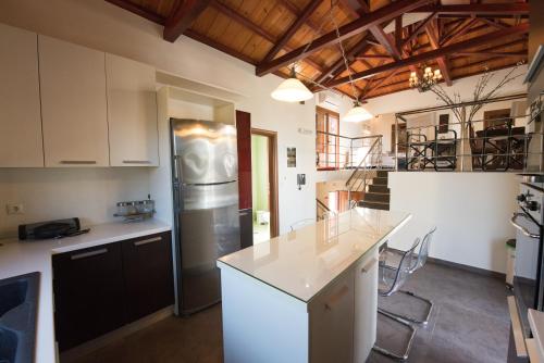 a kitchen with a refrigerator and a counter top at Gallis Villa in Pefkias