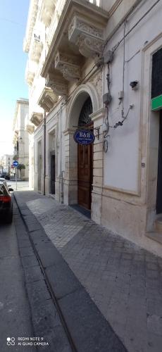 a building with a sign on the side of a street at Casa Cristina in Siracusa
