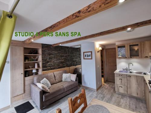 a living room with a couch and a kitchen at Chalet ZenArcs in Bourg-Saint-Maurice