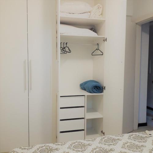 a bedroom with a bunk bed and a closet at Serena Morro in Morro de São Paulo