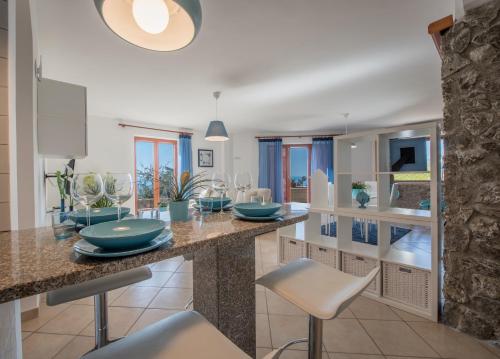 a kitchen with a large island with blue dishes on it at Villa Marianna in Massa Lubrense