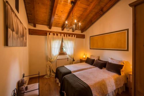 a bedroom with a bed and a chandelier at CASUCAS LA GUARIZA ( Casa Marta) in Fontibre