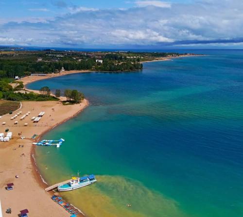 an aerial view of a beach with a boat in the water at Kristall Hotel in Bosteri