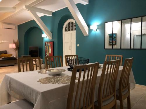 une salle à manger avec une table et des chaises blanches dans l'établissement Arche de Portissol Sanary Appartement de charme 4 à 6 personnes, à Sanary-sur-Mer