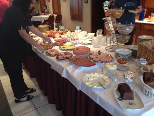 a long table with a buffet of food on it at Hotel Herbstein in Herbstein