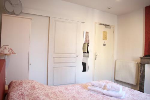 a bedroom with a bed with two towels on it at Hotel Saint Yves in Nantes