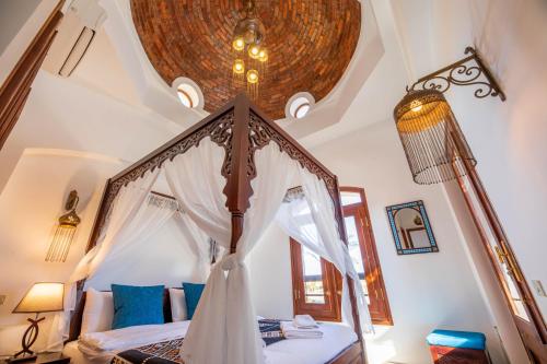 a bedroom with a canopy bed with a ceiling at Charming Lagoon Villa with pool Egyptian Style -Sabina 117 in Hurghada