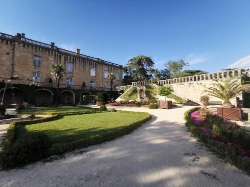 a walkway in front of a large brick building at Studio atypique Immeuble de 1820 in Fumel