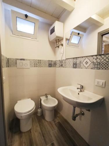 a bathroom with a toilet and a sink at Casa Liò in Santa Flavia
