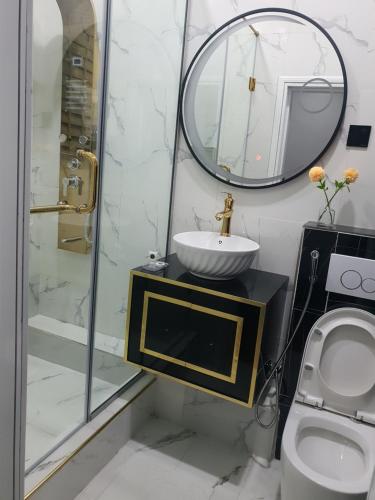 a bathroom with a sink and a mirror and a toilet at Executive Home Extension in Lagos