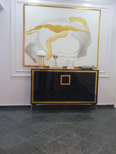 a table in a room with a painting on the wall at Executive Home Extension in Lagos