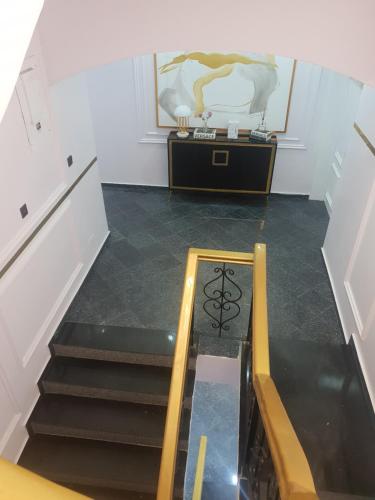 a room with stairs and a table with a picture on the wall at Executive Home Extension in Lagos