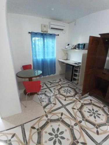 a living room with a table and a table and a kitchen at Grace Garden Guesthouse by Eminence Ent in Ocho Rios