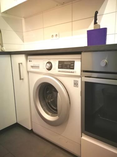 a washing machine in a kitchen with a counter at Central-Apt at Lake, CityCenter 5min, Fair 18min!!! in Nürnberg